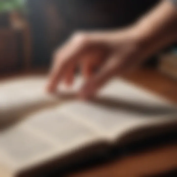 A close-up of a hand turning the page of a classic book